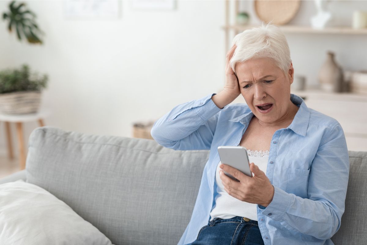 Grandparent scam image of distressed person on their phone