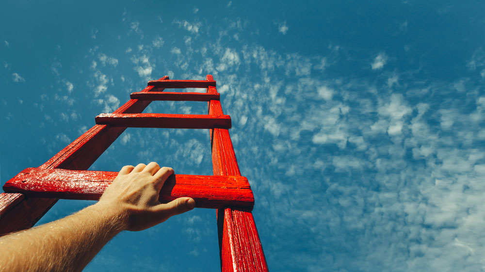 hand holding a ladder towards the open sky