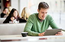 Man uses tablet to check investments