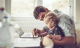 online banking safely at home father and daughter sit at a laptop at home