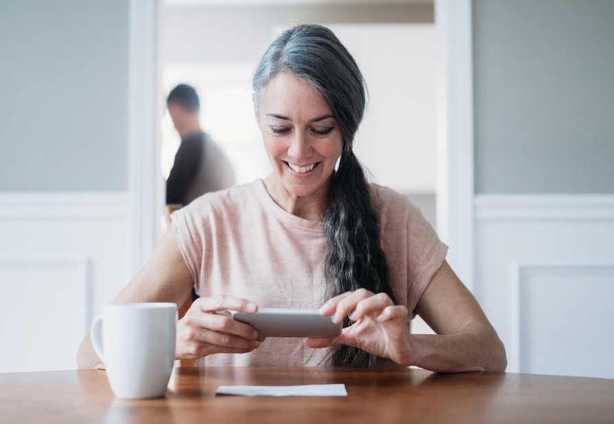 Woman deposits cheque with phone
